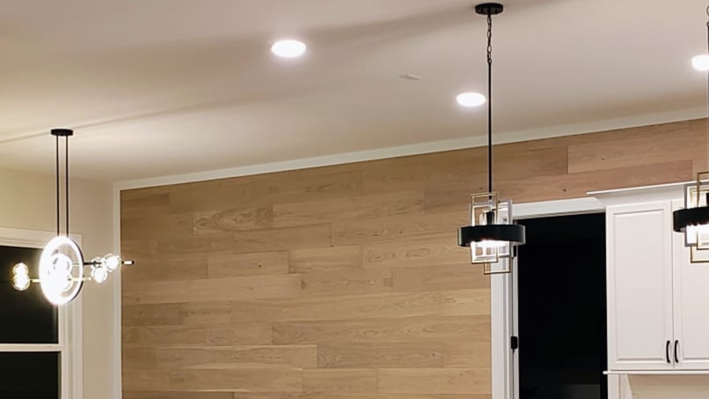 White oak plank accent wall beside a kitchen