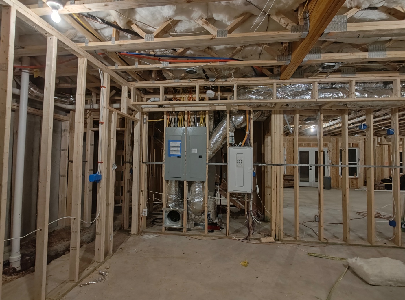 Panels, air handler, and tankless heater in one serviceable wall