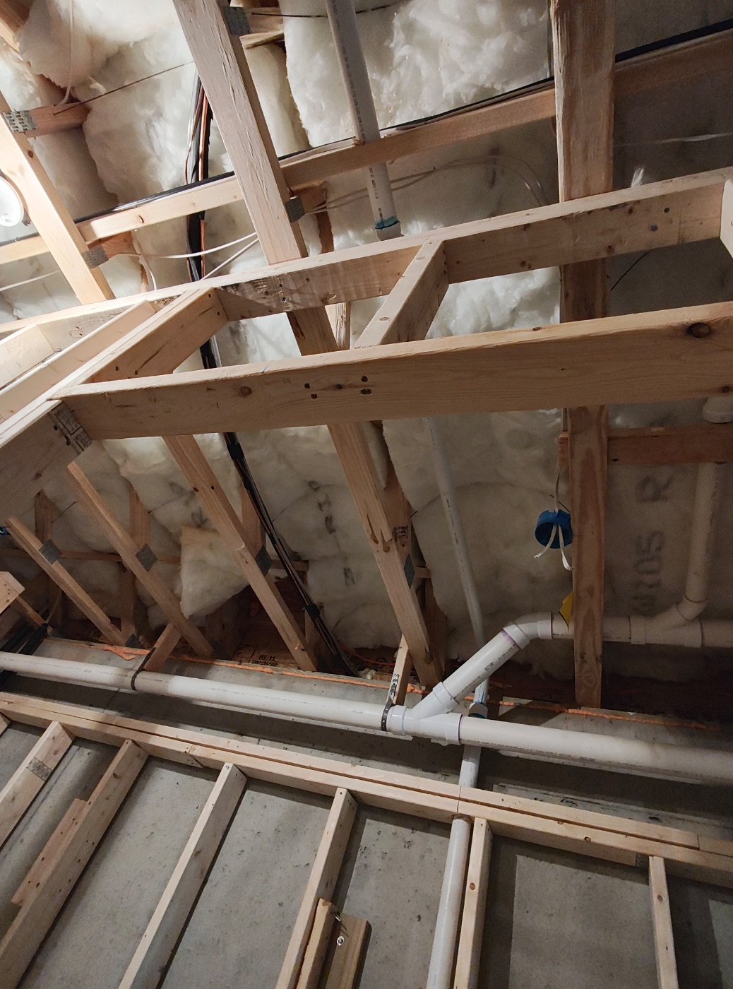 Waste and vent carried overhead through the joist bays
