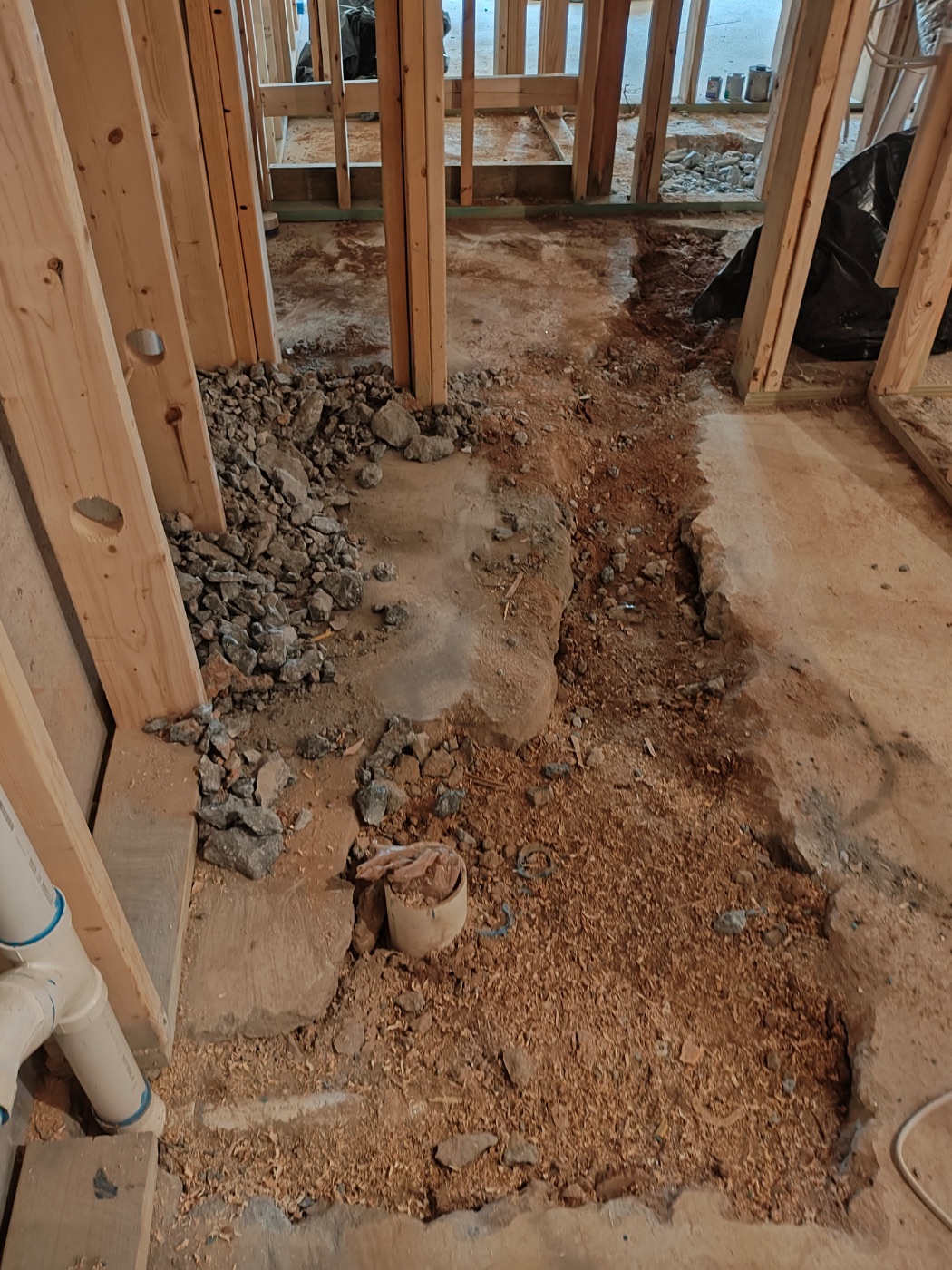Trench cut across the room to reach the real fixture wall